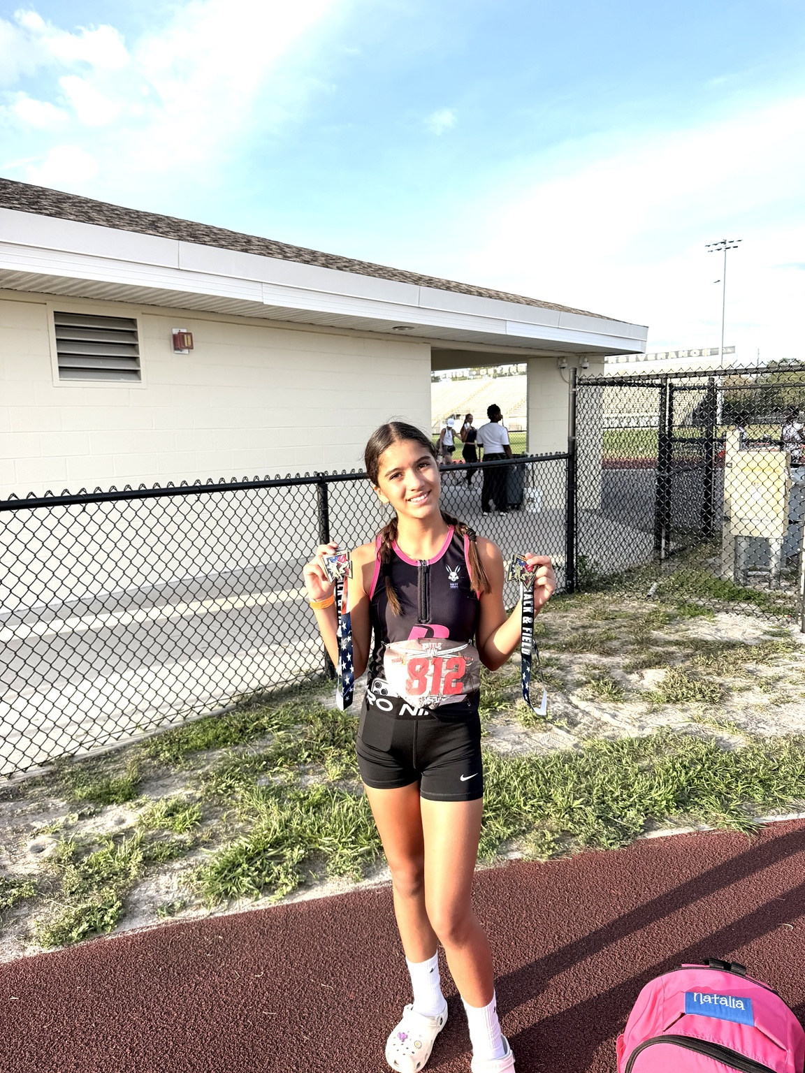 Track athlete proudly showing two medals