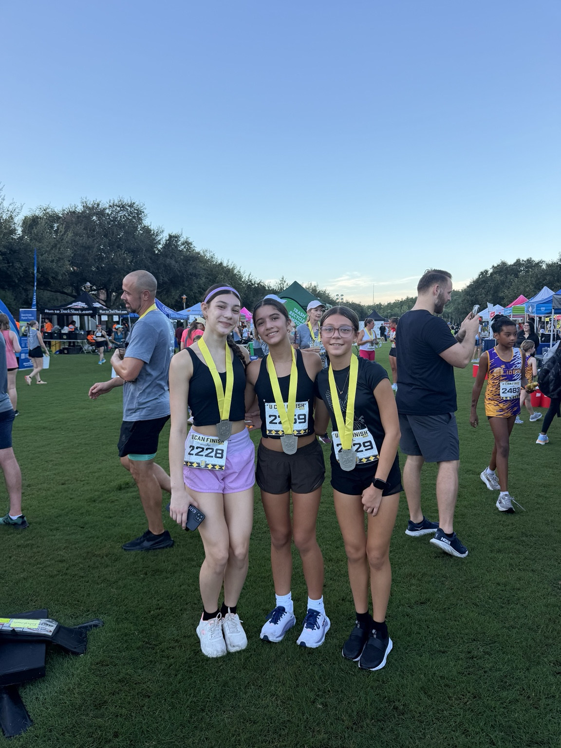 Three young athletes with race medals