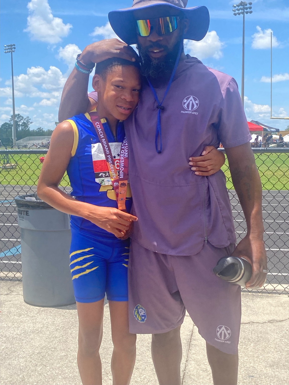 Coach standing with athlete after competition