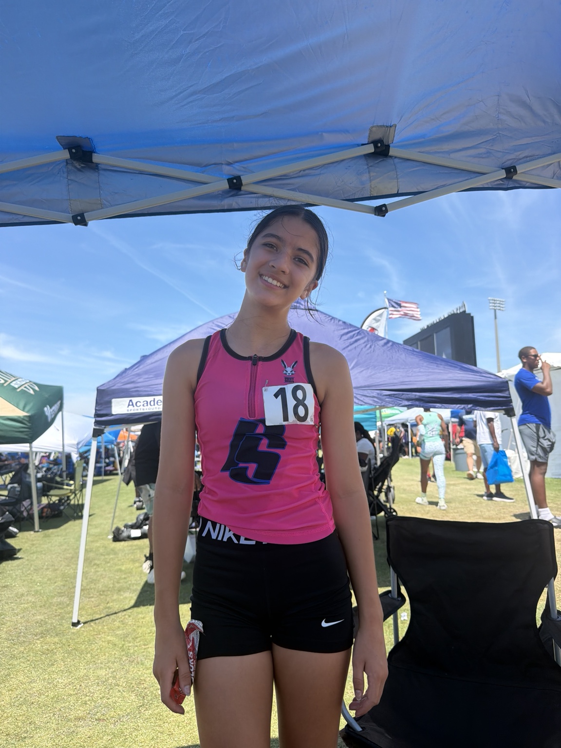 Athlete in pink FS uniform posing at the meet