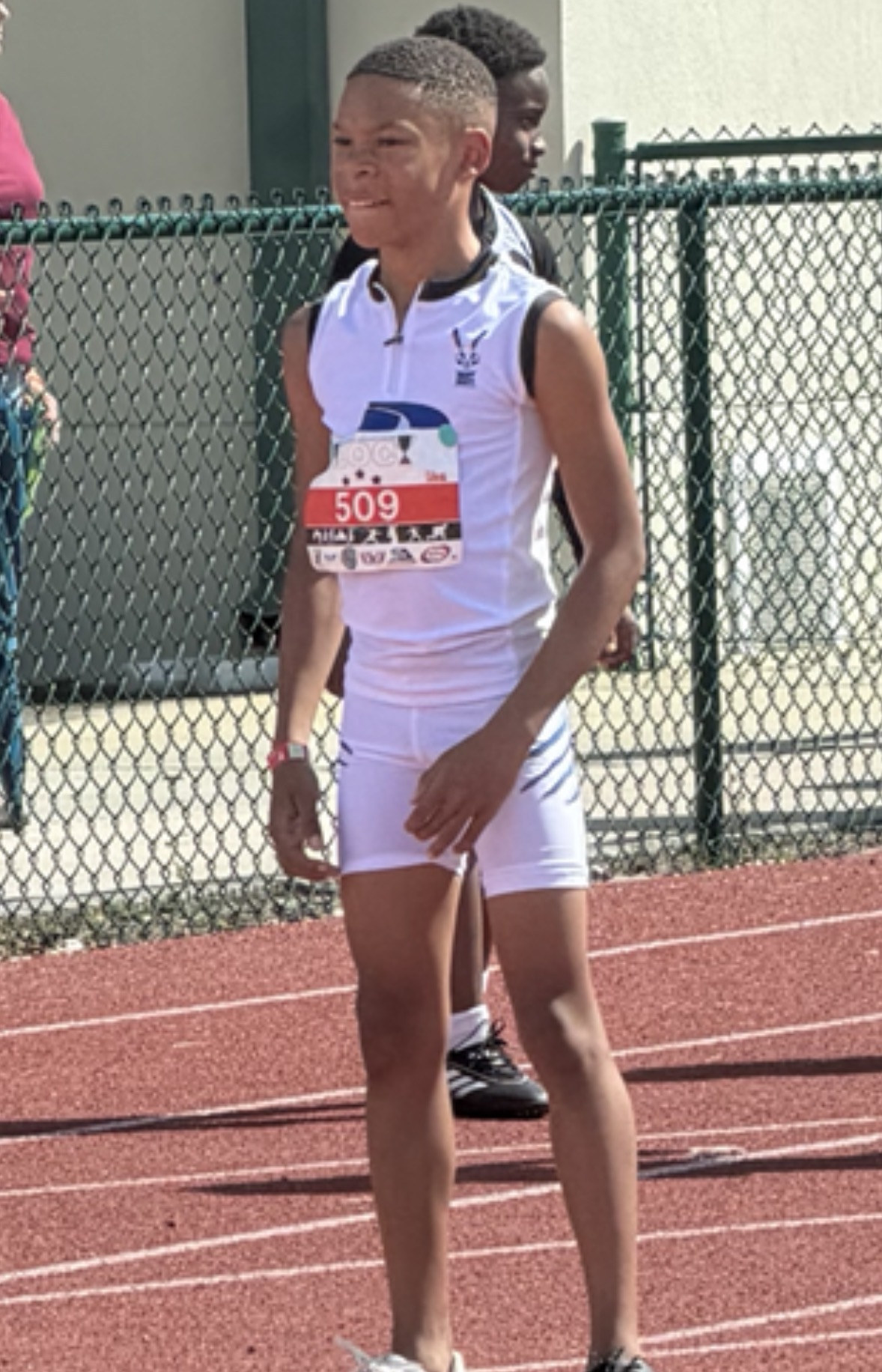 Young track competitor in white uniform