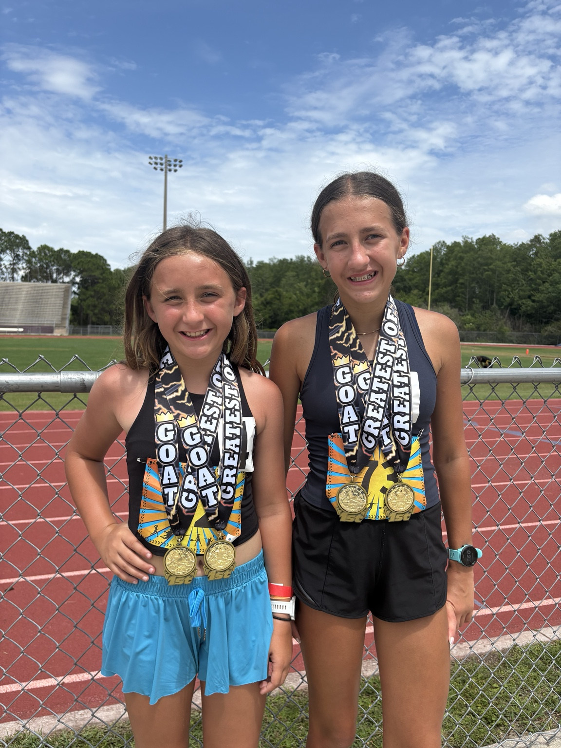 Two young runners with gold medals
